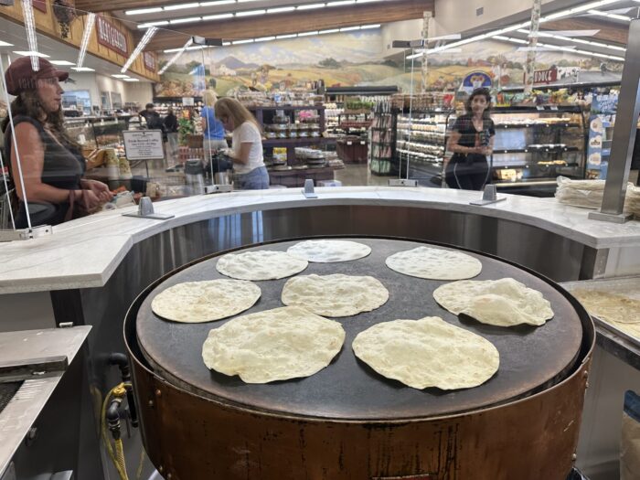 Employees make fresh handmade tortillas daily at Windmill Farms in Del Cerro, San Diego CA, using the original Pancho Villa tortilla machine to craft authentic Mexican tortillas.